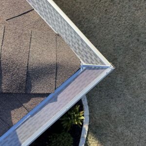 a-close-up-of-a-roof-with-a-metal-gutter