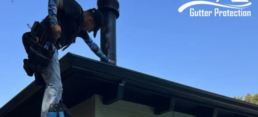Technician from Austin Gutter Protection performing gutter repair in Austin on a house roof, ensuring proper installation and protection against water damage.